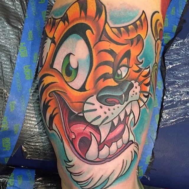 Funny cartoon like colored smiling tiger face tattoo