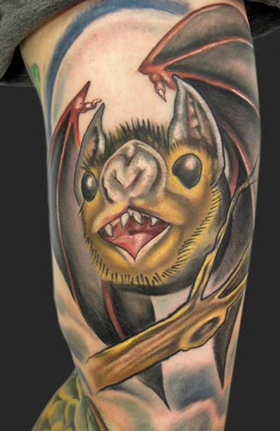 Funny cartoon like colored vampire bat tattoo on arm