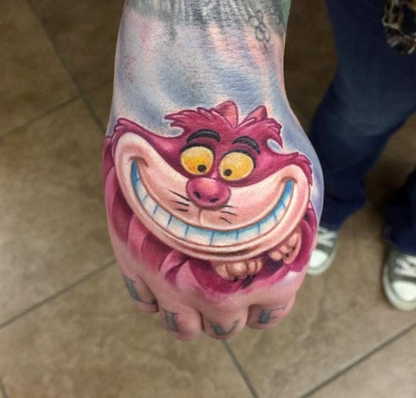 Funny cartoon smiling Cheshire cat bright colored hand tattoo
