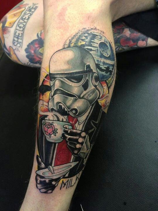 Funny deigned colored drinking tea storm trooper in suit tattoo on leg combined with death star