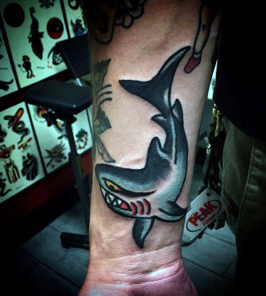 Funny design colored old school style shark tattoo on forearm area