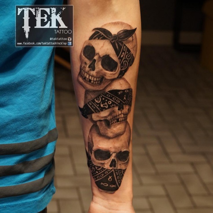 Funny designed and colored forearm tattoo of gangsta human skulls