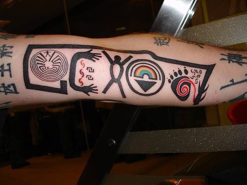 Funny designed and colored various tribal symbols tattoo on sleeve