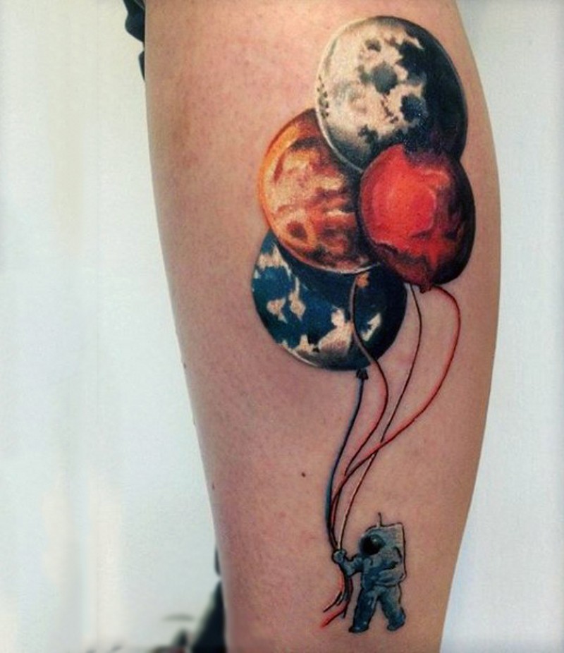 Lustiger großer farbiger Astronauten mit Planeten in der Form von  Ballons Tattoo am Bein
