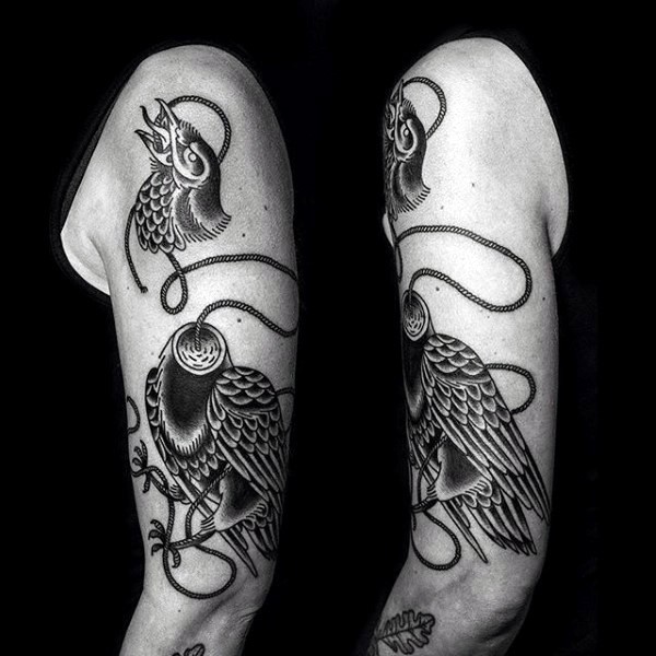 Funny designed black and white eagle with roped head arm tattoo