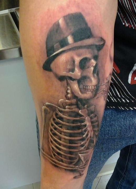 Funny detailed 3D realistic style skull in hat tattoo on arm