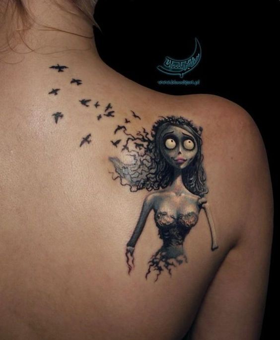 Funny famous monster cartoon hero colored tattoo on shoulder with birds