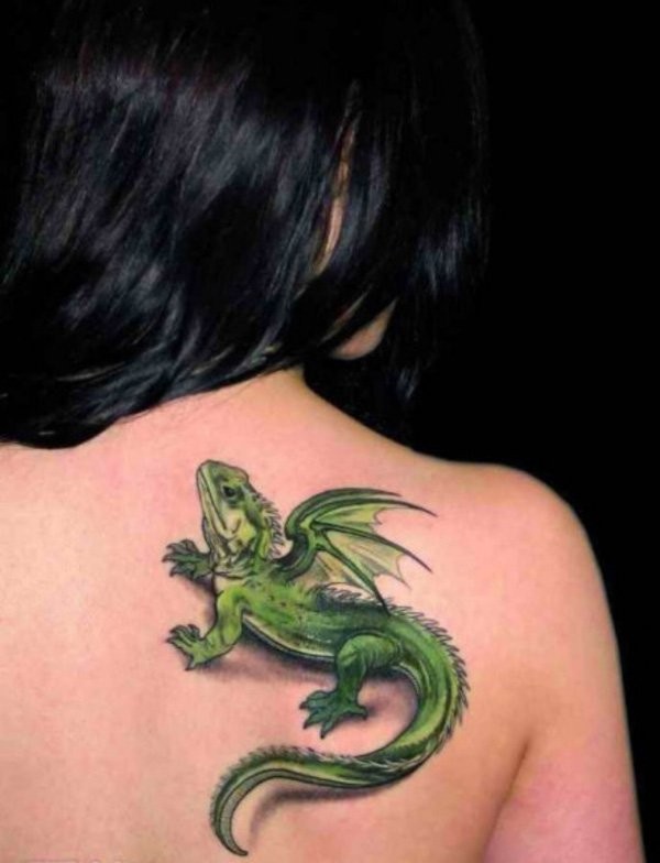 Funny looking 3D style green colored small dragon lizard tattoo on upper back