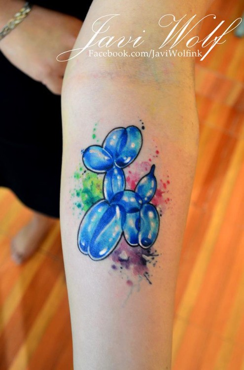 Funny looking colored balloon dog tattoo on forearm