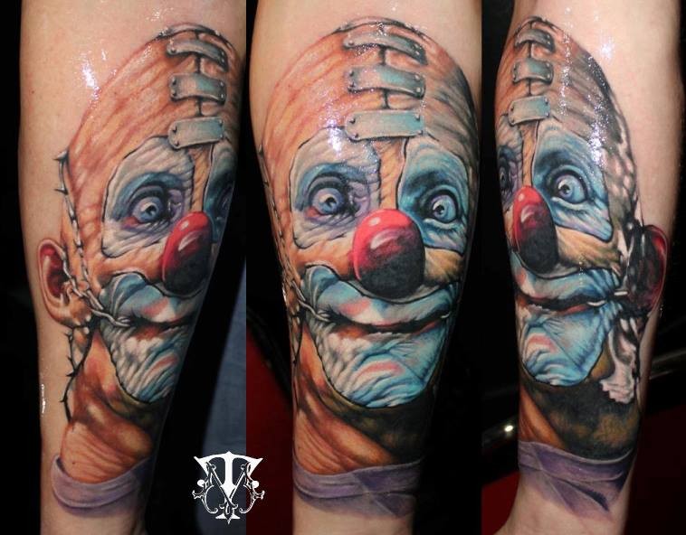 Funny looking colored crazy clown tattoo