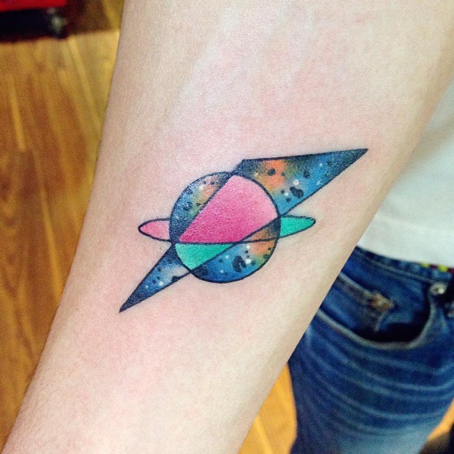 Funny looking colored forearm tattoo of geometrical figures stylized with space view