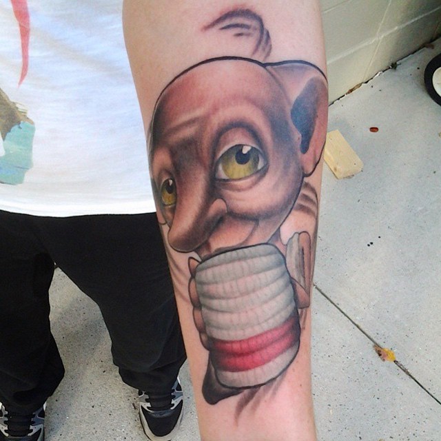 Funny looking colored forearm tattoo of Harry Potter movie monster