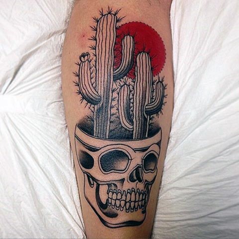 Funny looking colored leg tattoo of human skull with cactus