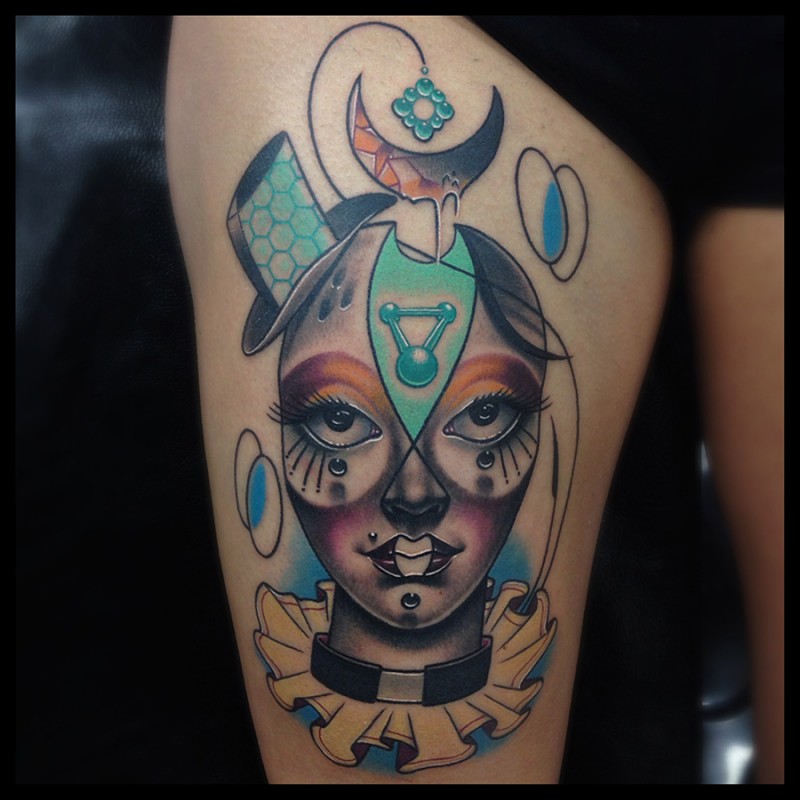 Funny looking colored thigh tattoo of clown woman with various symbols