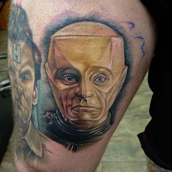 Funny looking colored thigh tattoo of robot face