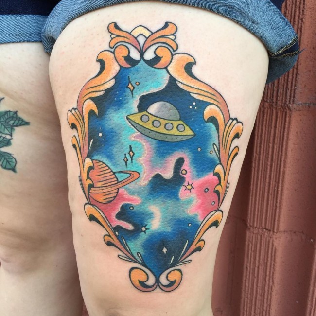 Funny looking thigh tattoo of space ship with stars portrait