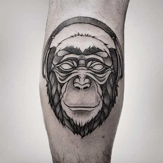 Funny monkey&quots head with headphones tattoo