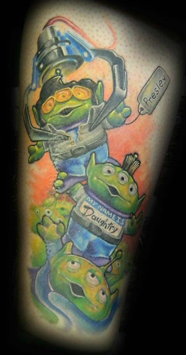 Funny multicolored cartoon aliens tattoo with lettering