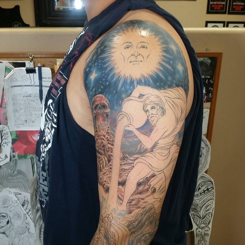 Funny mystical looking half colored shoulder tattoo with sun, skull and Aquarius symbol