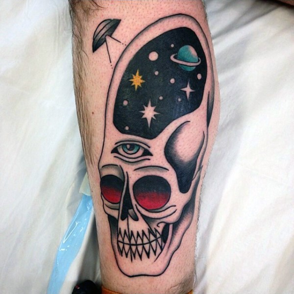 Funny painted big colored skull with eye and space tattoo on leg