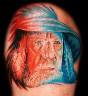 Funny painted colorful natural looking shoulder tattoo of Gandalf wizard