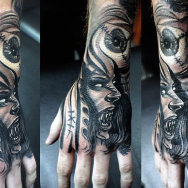Futuristic black ink horrifying vampire woman with eye tattoo on wrist