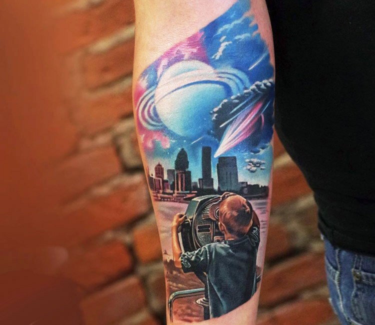 Futuristic illustrative style boy with city sights and planets tattoo on forearm