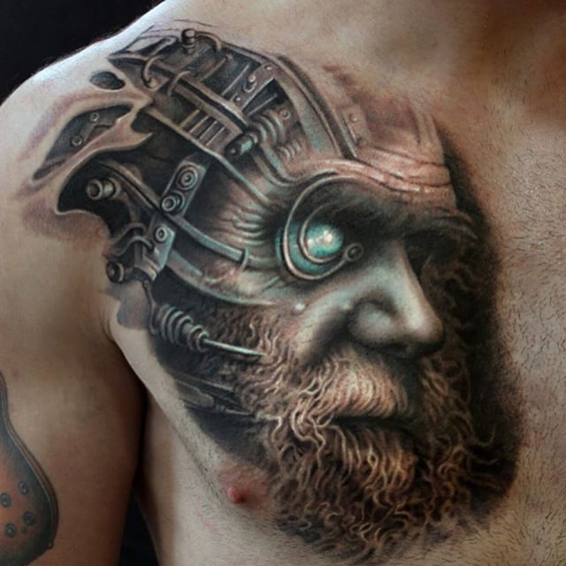 Futuristic style big colored biomechanical man portrait tattoo on chest