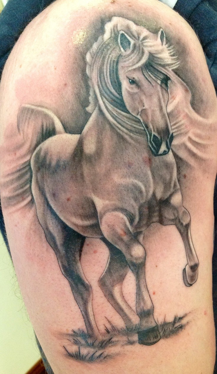 Galloping horse tattoo on arm