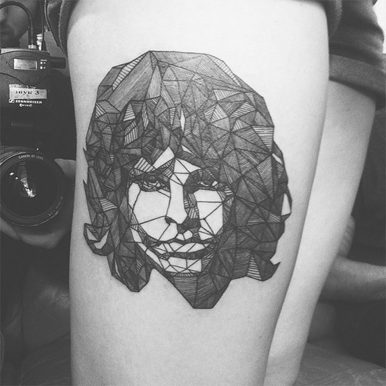 Geometric style black and white thigh tattoo of woman portrait