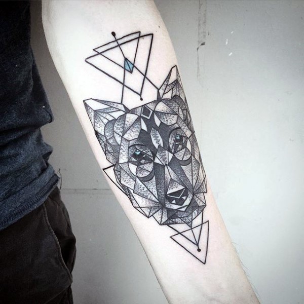 Geometrical style colored forearm tattoo of wolf head with geometrical figures