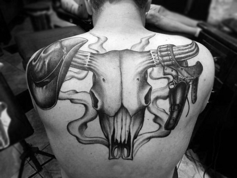 Giant bull skull with cowboy&quots hat and revolver on horns tattoo on back