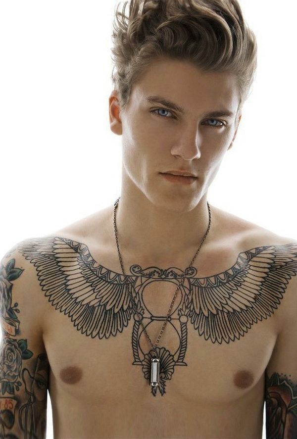 Giant feather wings and sand clock black ink tattoo on man&quots chest