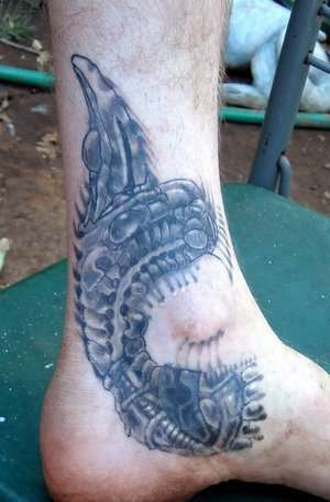Giger art tattoo on foot