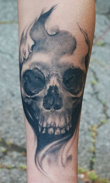 Gloomy gray skull forearm tattoo