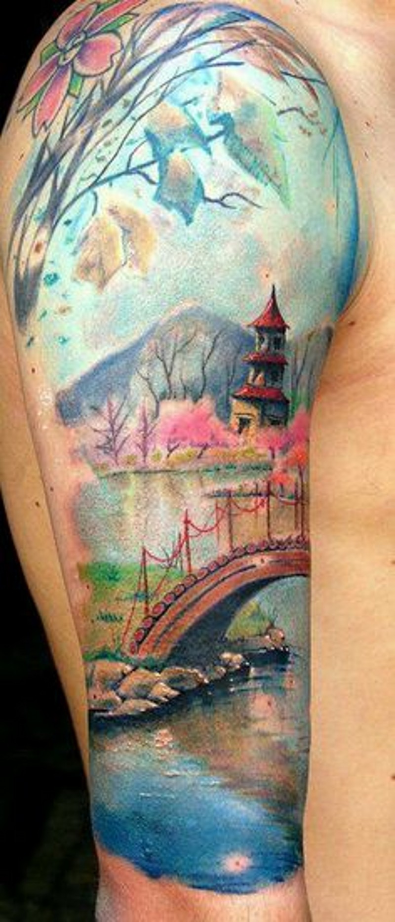 Glorious antic painting like colored Asian house in blooming garden tattoo on shoulder combined with mountain river and bridge