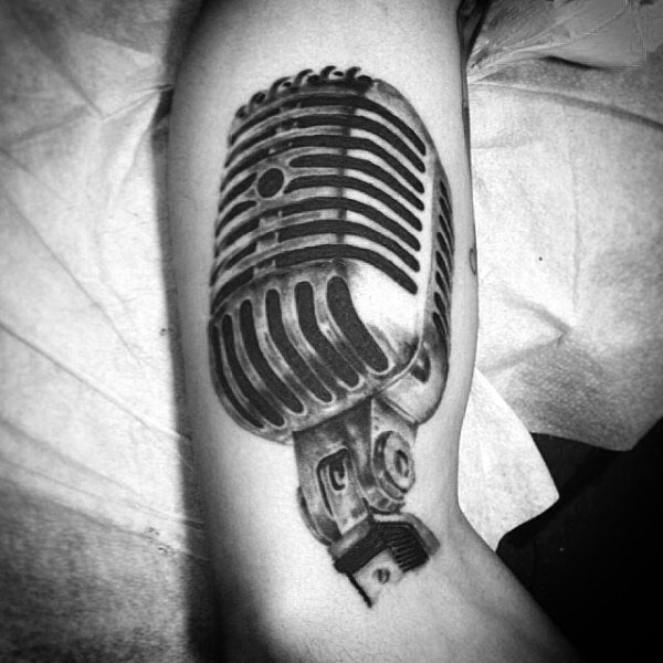 Gorgeous black and white realistic microphone tattoo on arm