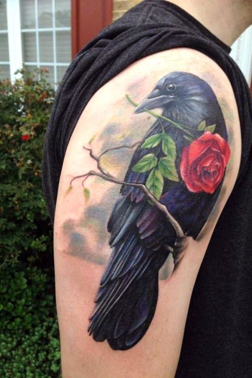 Gorgeous black crown with red rose in beak super realistic shoulder length tattoo
