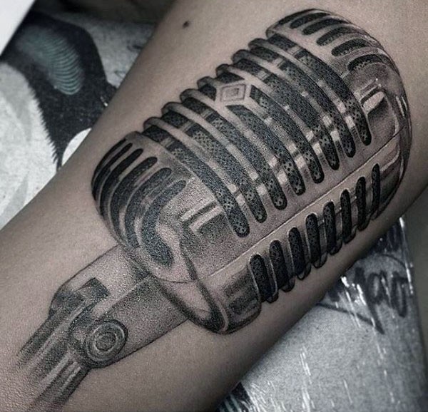 Gorgeous black ink very detailed microphone tattoo on arm
