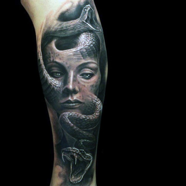 Gorgeous colored and painted Medusa portrait tattoo on leg