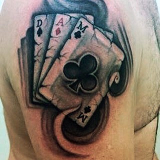 Gorgeous colored playing cards upper arm gambling tattoo