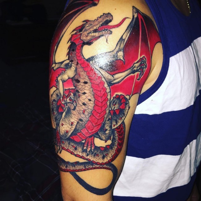 Gorgeous designed and colored shoulder tattoo of fantasy dragon