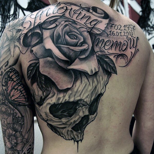 Gorgeous designed and painted massive memorial flower with lettering and skull tattoo on whole back