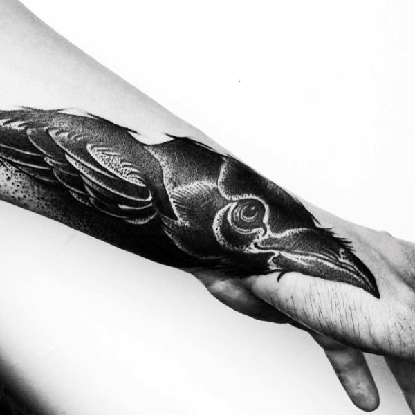Tatuaje de cuervo  negro blanco en el antebrazo