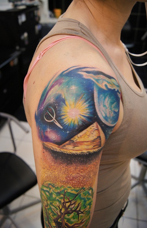 Gorgeous looking colored Egypt pyramid tattoo on shoulder with space and tree