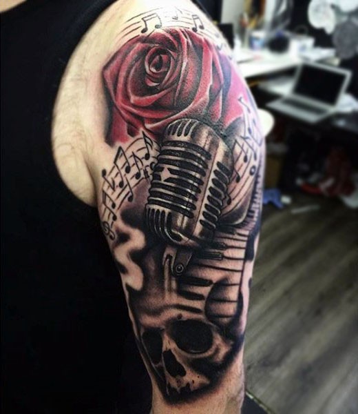 Gorgeous multicolored red colored flower with microphone and skull shoulder tattoo