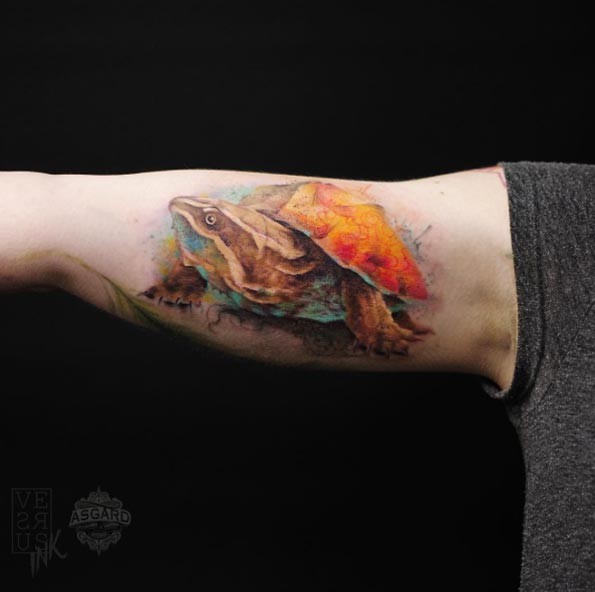 Gorgeous natural looking multicolored biceps tattoo of big turtle