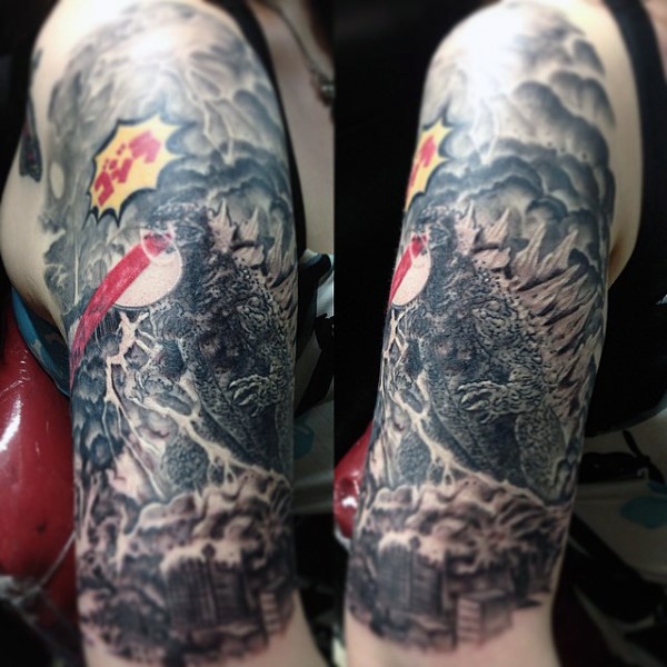 Gorgeous painted and colored massive evil Godzilla tattoo on half sleeve area