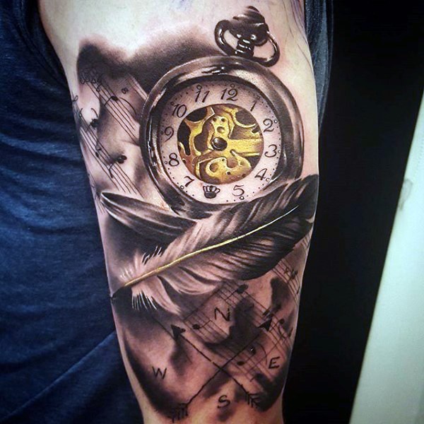 Gorgeous painted colored old mechanic clock with notes and feather tattoo on arm