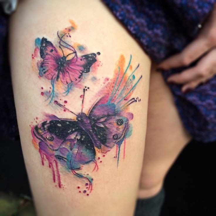 Gorgeous pair of colorful butterflies tattoo on lady;s thigh in watercolor style